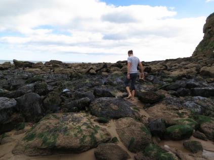Tobi exploring seaweed rocks on Tynemouth Beach